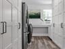 Oversized Laundry Room with Extra Refrigerator and Ample Storage