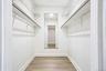 Primary bedroom walk in closet