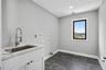 Laundry room featuring washer hookup, hookup for an electric dryer, cabinet space, and recessed lighting