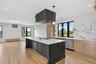Kitchen featuring light brown cabinetry, stainless steel appliances, light stone counters, healthy amount of natural light, and recessed lighting