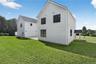 Rear view of house featuring a lawn and a patio