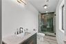 Bathroom featuring a shower stall, vanity, and recessed lighting