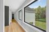 Hall with light wood finished floors and recessed lighting