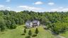 View from above of property with a forest