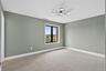 Unfurnished room featuring baseboards and light carpet
