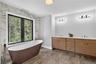 Bathroom featuring a soaking tub and double vanity