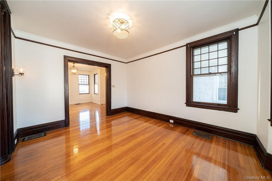 Formal Living Room with high ceilings, refinished hardwood floors throughout and freshly painted.