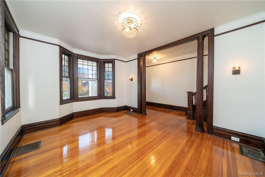 Formal Living Room with a view into the Entry Foyer. Freshly painted throughout, refinished hardwood floors with all new light fixtures!