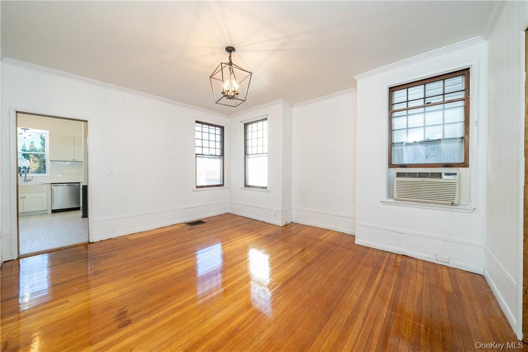 Formal Dining Room with new light fixtures and refinished hardwood floors as seen.