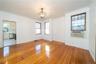 Formal Dining Room with new light fixtures and refinished hardwood floors as seen.