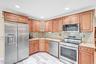Cabinet lined kitchen with stainless steel appliances