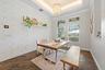 A spacious Dining Room with view of the Front Porch allowing ample Natural Light to flow through the home effortlessly.