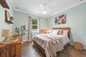 This Bedroom boasts a Queen Bed with view of the back yard space + has a custom built closet as well!
