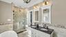 Primary en suite bathroom with soaking tub and separate shower, double vanity