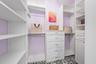 Ample storage in the Primary Walk-In Closet complete with the most perfect chandelier!