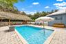 This back yard oasis literally has it ALL! Salt Water + Heated Pool + Sauna + 20' x 40' Tiki Hut, plus a Summer Kitchen complete with Gas Grill, 2 Ref