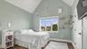 Bedroom with soaring ceilings, water view