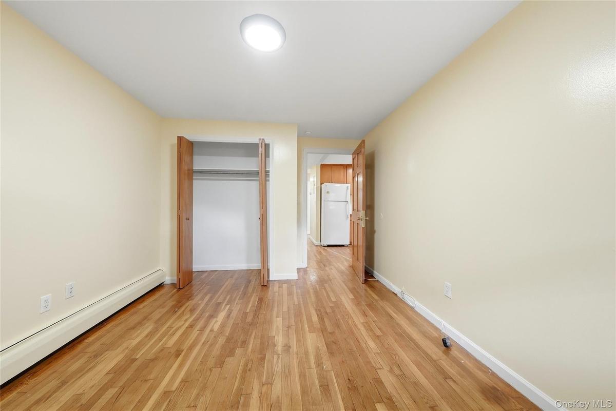 Hardwood flooring, neutral wall tones, built-in closet, and recessed lighting