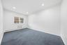 Recessed lighting, window with white trim, baseboard heating, and wall-to-wall carpeting