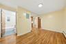 Hardwood flooring throughout, recessed ceiling light, paneled doors, and light-toned walls
