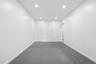 Recessed ceiling lighting, white walls, two paneled interior doors, and grey carpeting