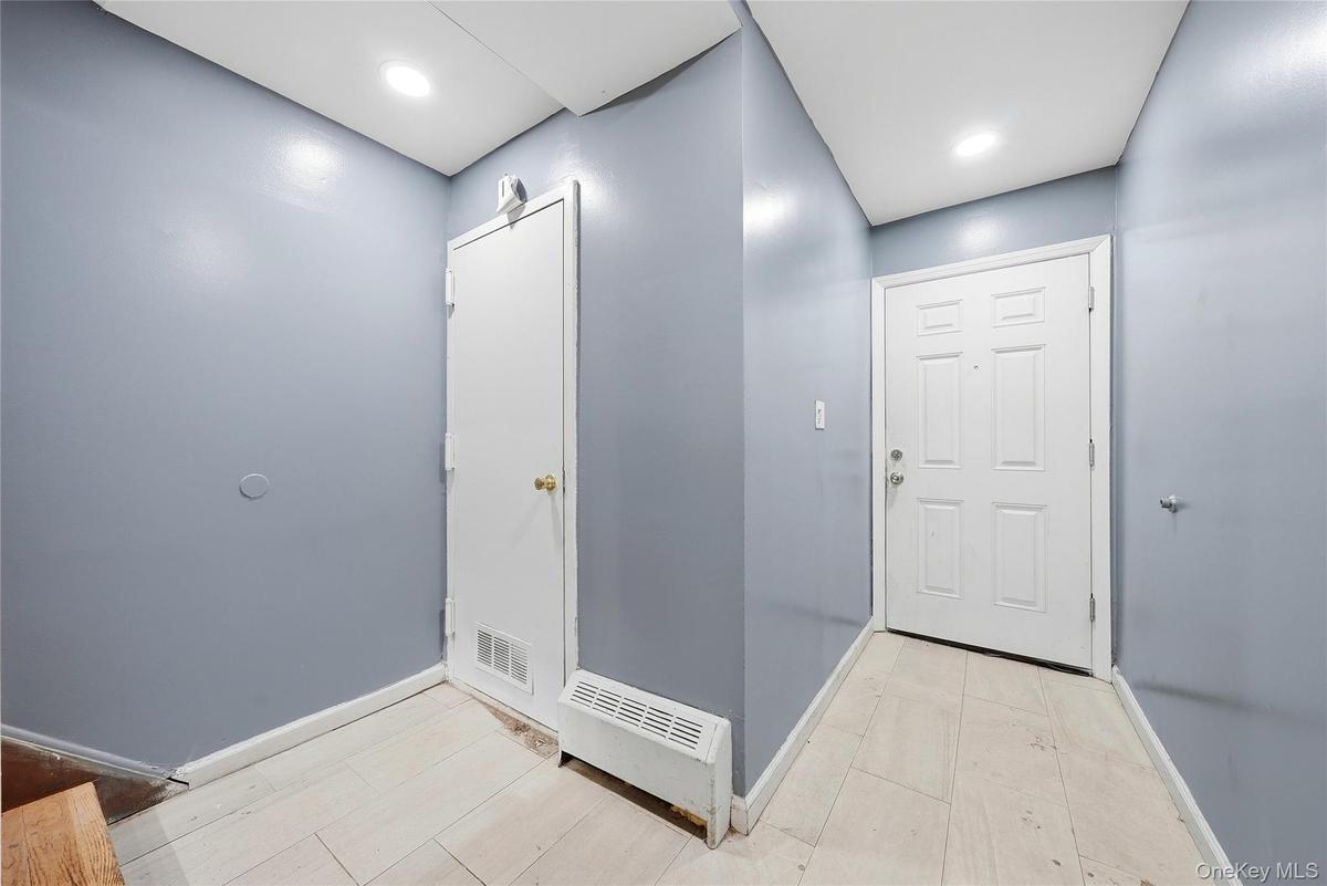 Entryway featuring light-colored flooring and recessed lighting