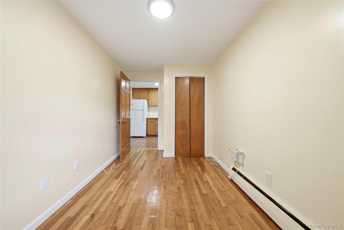 Hardwood-style flooring, light-toned walls, and a flush-mount ceiling light