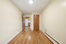 Hardwood-style flooring, light-toned walls, and a flush-mount ceiling light