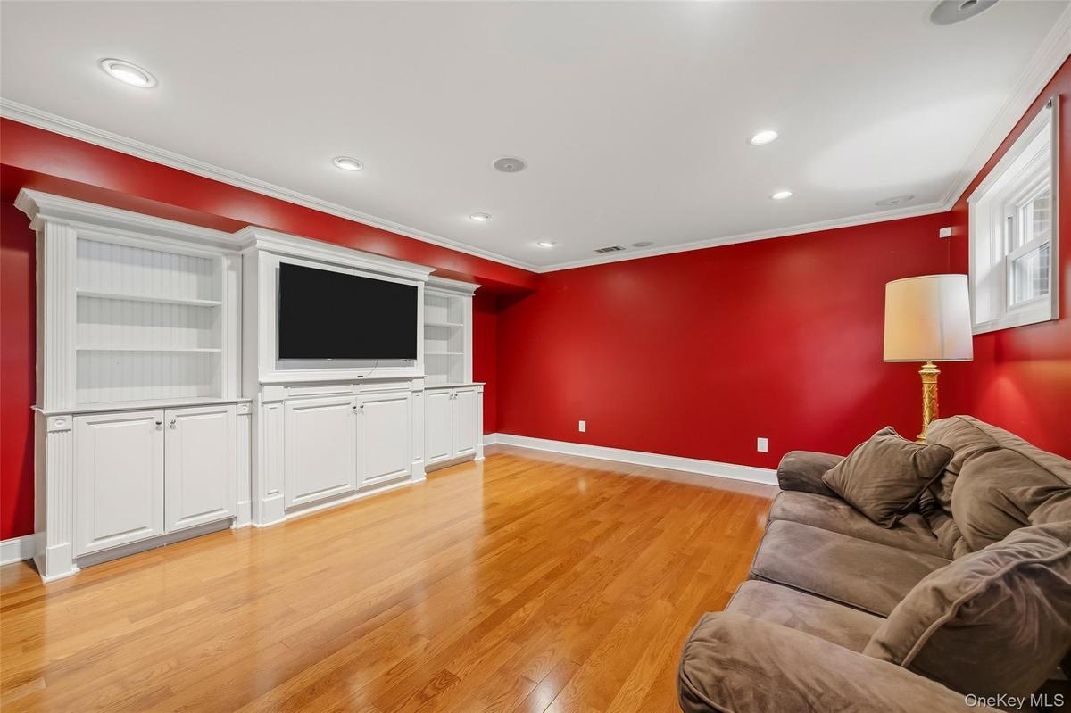 Hardwood floors, crown molding, recessed lighting, custom built-ins perfect for media center