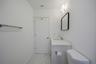 Bathroom with marble finish floors, vanity, toilet, and baseboards