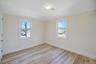 Empty room with light wood-type flooring and baseboards