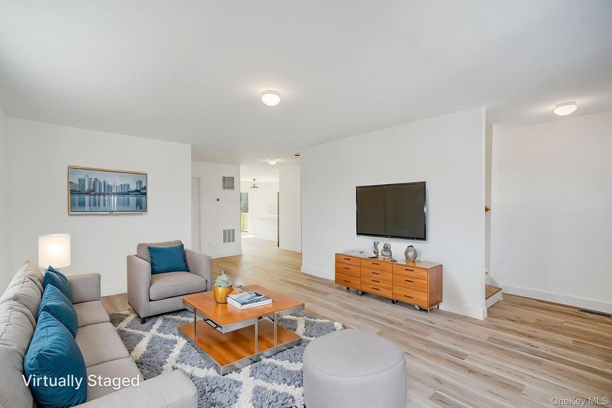 Living room with light wood-style floors and baseboards