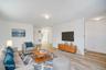 Living room with light wood-style floors and baseboards