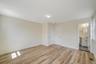 Unfurnished bedroom with light wood-type flooring, baseboards, connected bathroom, and a sink