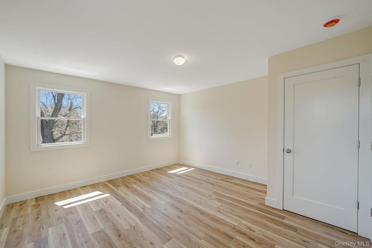 Empty room featuring light wood-style flooring and baseboards