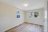 Spare room with plenty of natural light, baseboards, and light wood finished floors