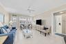 Light wood-finish flooring, crown molding, and a ceiling fan