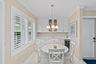 Separate dining area with extra storage and chandelier.