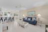 Open concept living area featuring light wood-look flooring, crown molding, a ceiling fan, and recessed lighting