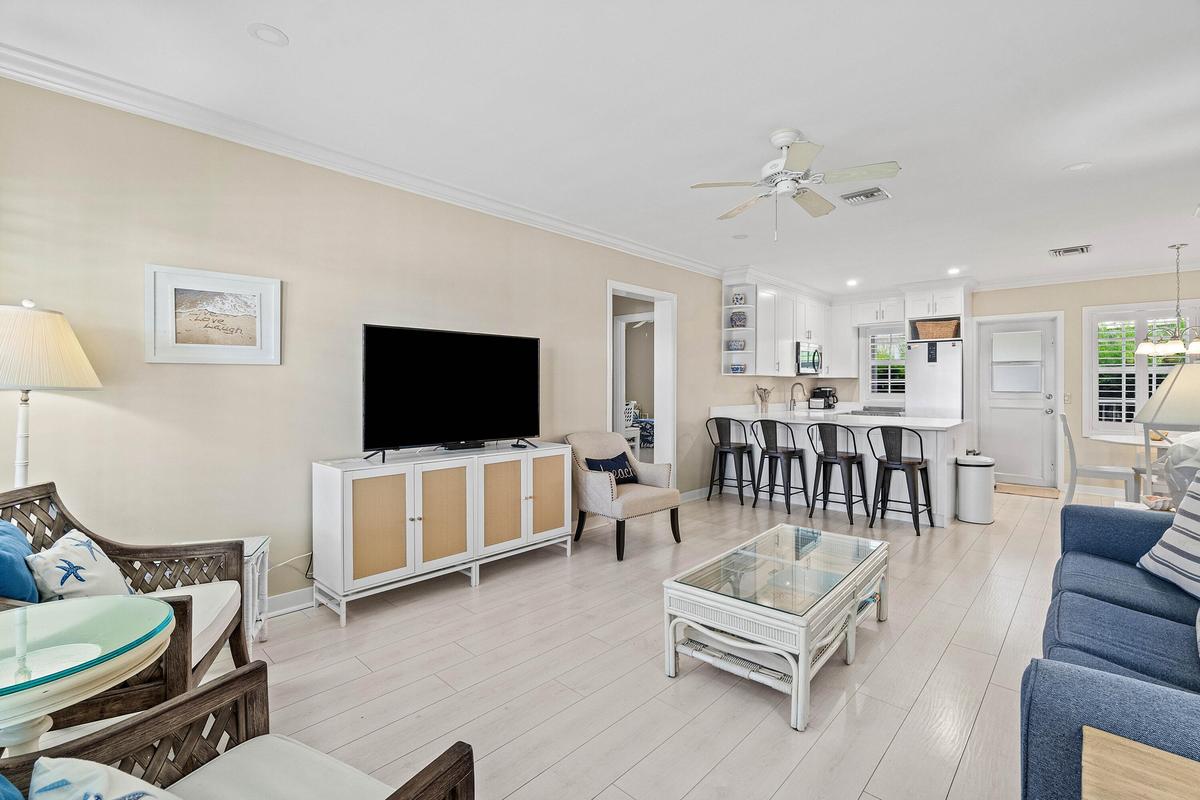 Bright open-concept living area with light wood-look flooring