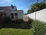 Side yard with Garden and gate access to driveway.