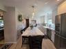 NEW Stunning Custom Kitchen w Center Island - seats 4, built-in microwave - Recessed Lighting & 3 Pendant Lights, Quartz Countertop, S/S appliances!