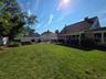 Fully Fenced Backyard with vinyl fencing and a covered patio for extra shade!