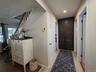 A hallway loaded with storage areas! Deep Closet underneath stairs, and a large pantry with custom cabinetry!