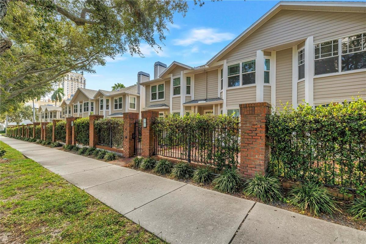 Tree-lined streetscape highlights the distinctive architecture and intimate residential setting of The Huntington.