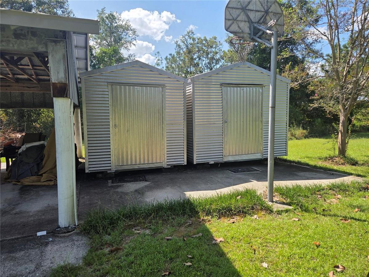 two Aluminum storage buildings.
