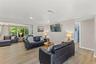 Spacious living area with luxury vinyl plank flooring, abundant natural light, and an open layout.