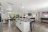 The large kitchen island anchors the open floor plan, connecting the kitchen to the dining and living areas.