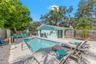 Private pool and patio create an easy outdoor extension of the home, with mature trees providing a natural backdrop.
