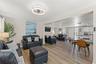 The open floor plan provides multiple gathering spaces with luxury vinyl plank flooring throughout—no carpet.
